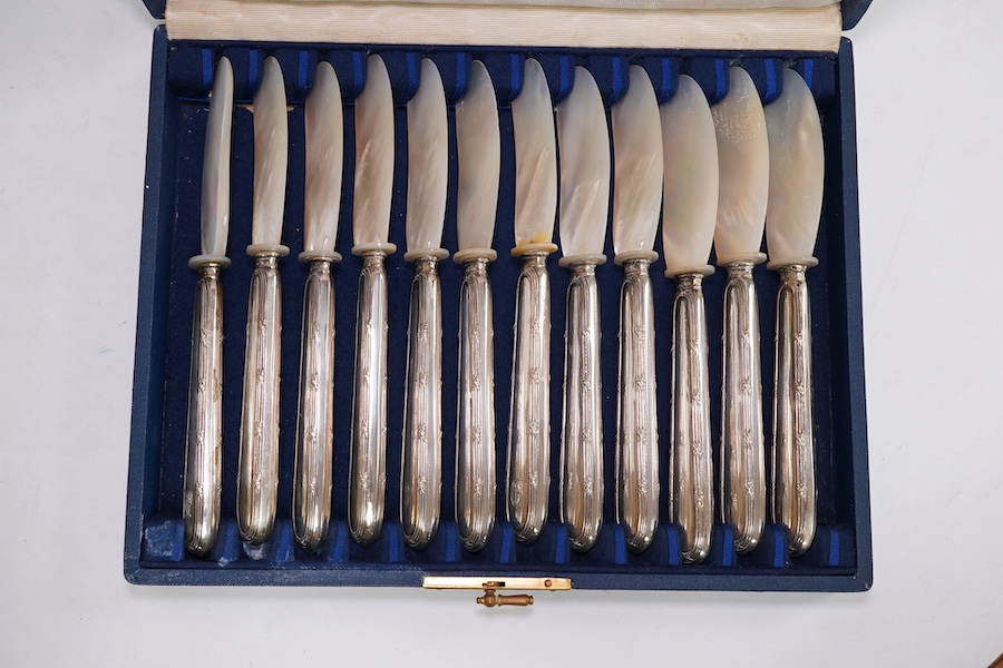 A cased set of German 800 standard white metal handled mother of pearl caviar knives, length 17cm, a cased set of six late 1950's silver and enamel coffee spoons, by Turner & Simpson (enamel a.f.) and a 19th century with